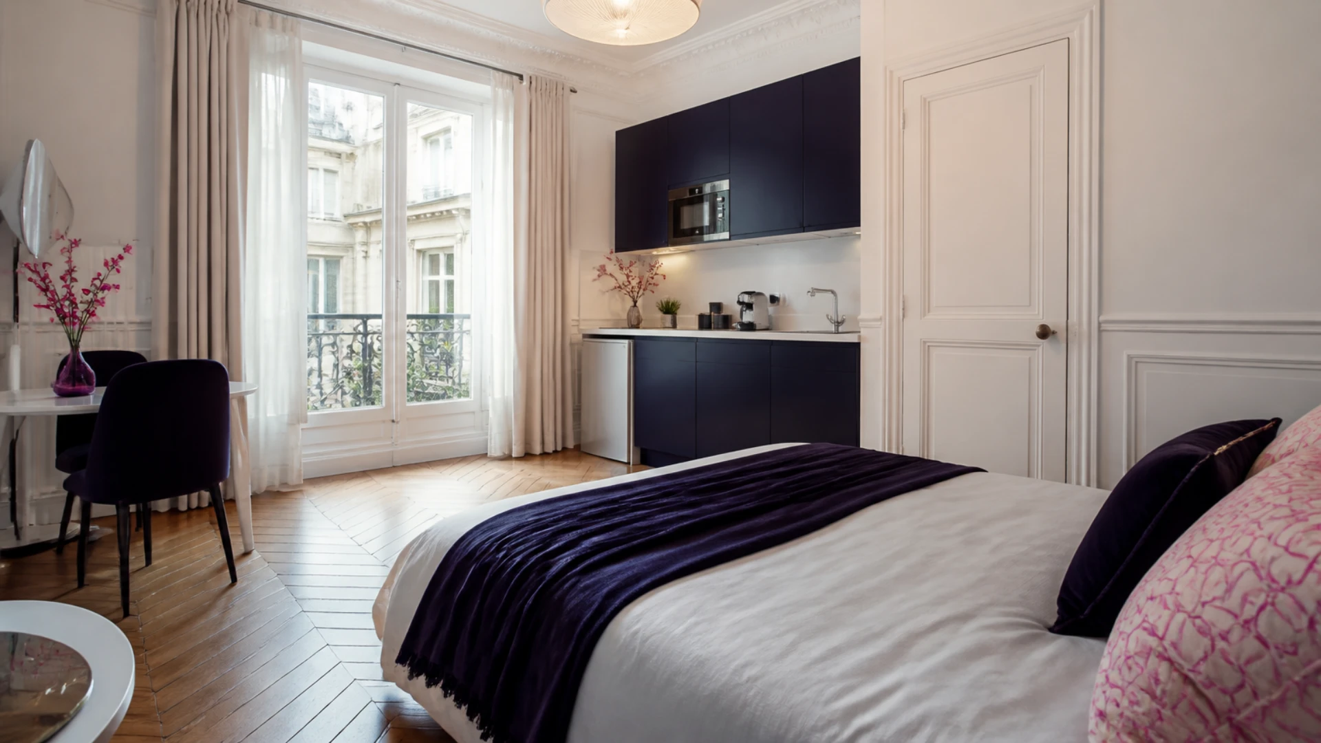 Studio meublé prêt à louer dans un immeuble haussmannien avec une porte fermée sur le côté